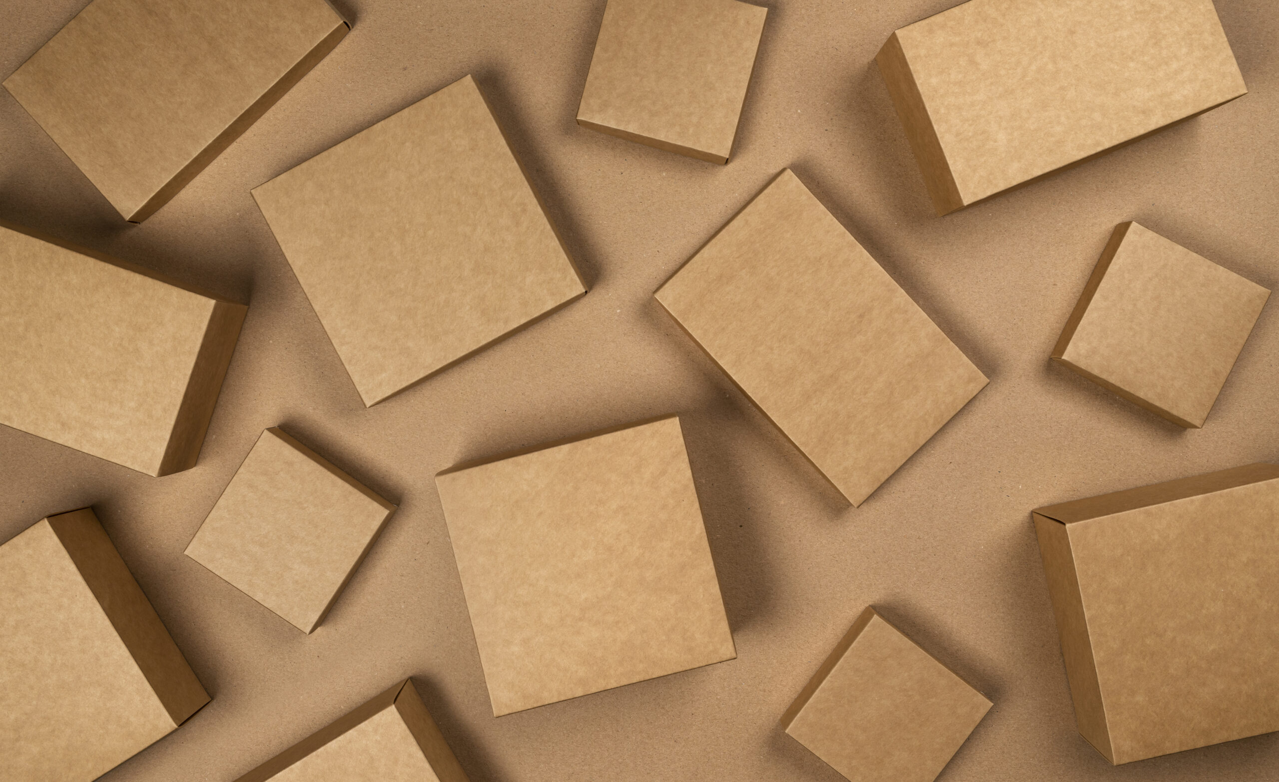 Brown cardboard boxes on craft paper background, top view